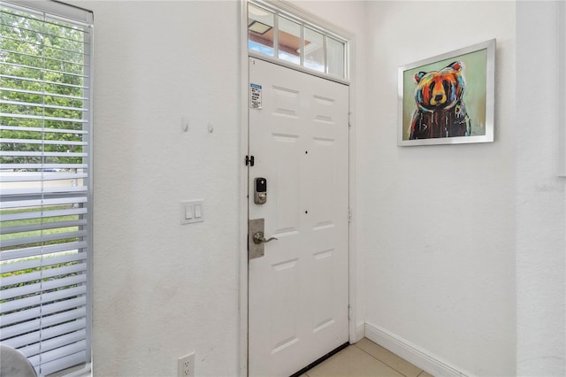 entryway with light tile patterned floors