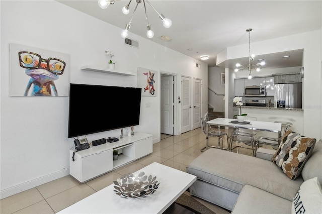 living room featuring light tile patterned floors and a notable chandelier