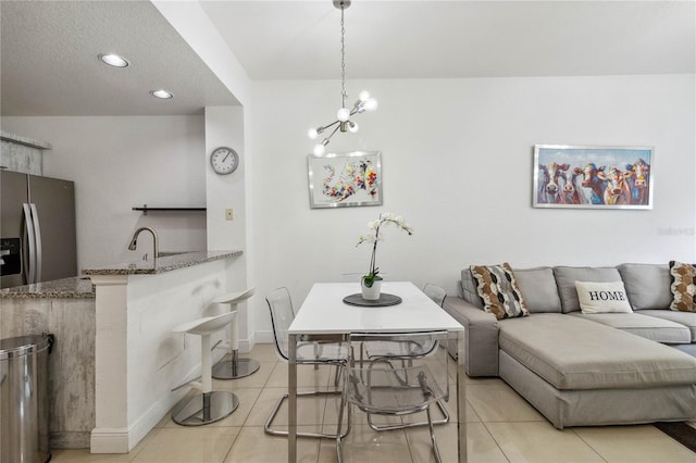 dining room with light tile patterned flooring and a chandelier