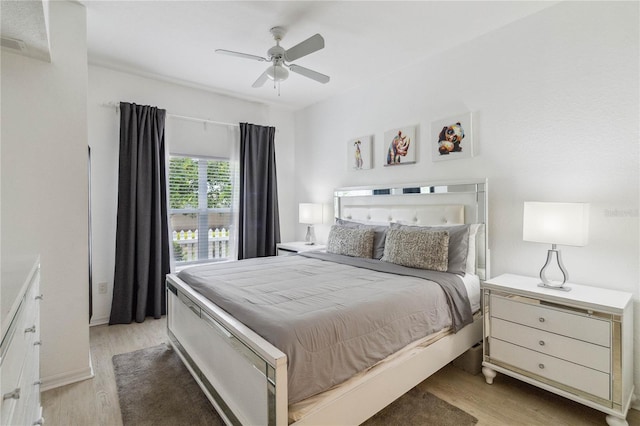 bedroom with light hardwood / wood-style floors and ceiling fan