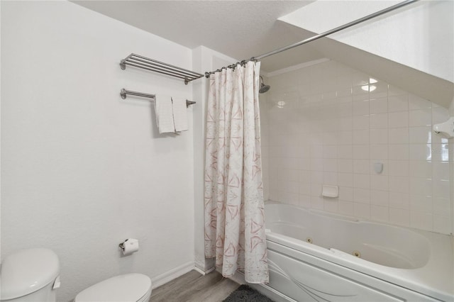 bathroom with toilet, wood-type flooring, shower / bath combo, and a textured ceiling