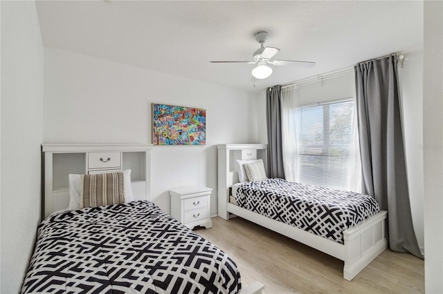 bedroom with ceiling fan and light hardwood / wood-style flooring