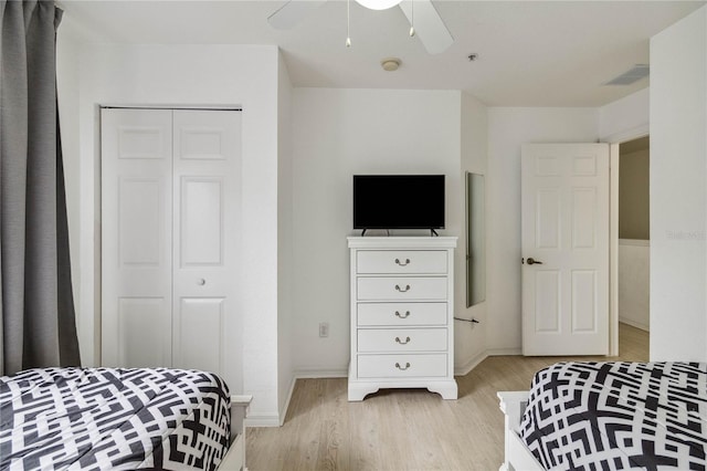 bedroom featuring ceiling fan, a closet, and light hardwood / wood-style floors