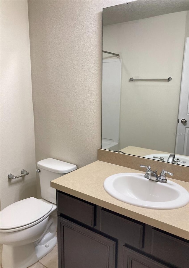 bathroom featuring oversized vanity and toilet