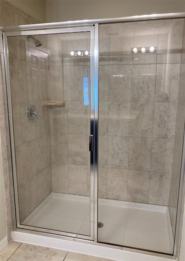 bathroom with walk in shower and tile floors