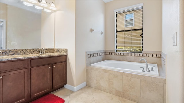 bathroom featuring tiled tub, tile patterned floors, and vanity