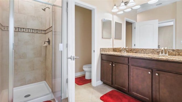 bathroom featuring an enclosed shower, tile patterned flooring, toilet, and double sink vanity