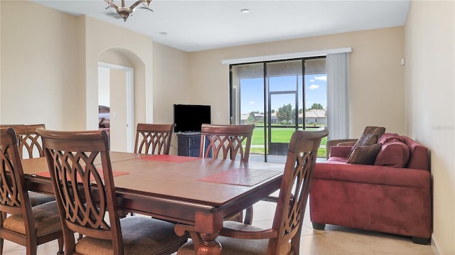 tiled dining area with a notable chandelier