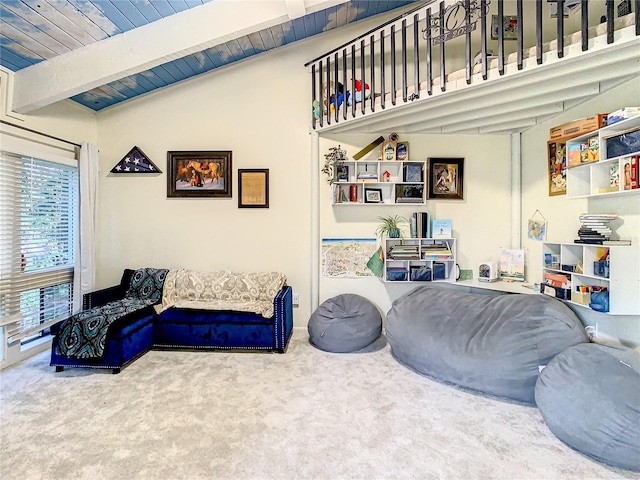 carpeted living room featuring lofted ceiling with beams and wooden ceiling