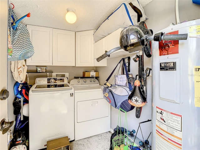 laundry room featuring separate washer and dryer, water heater, cabinets, and a textured ceiling