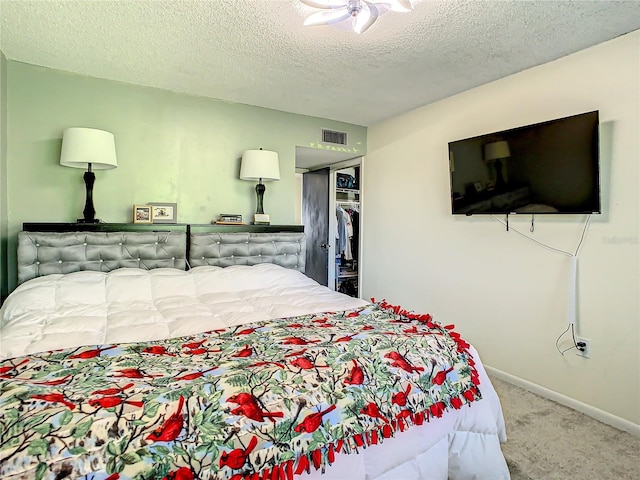 carpeted bedroom featuring a closet and a textured ceiling