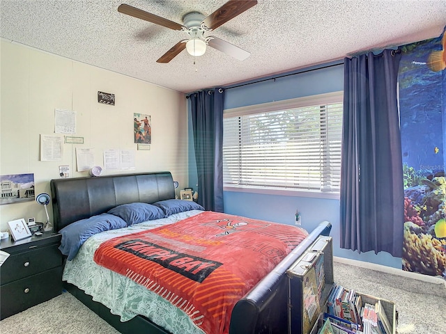 carpeted bedroom with ceiling fan and a textured ceiling