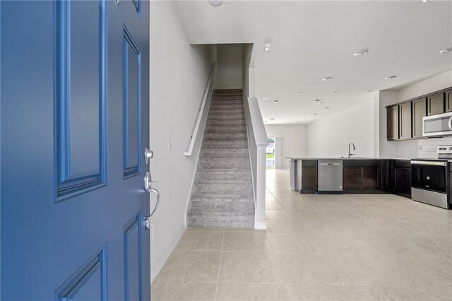 tiled foyer entrance with sink