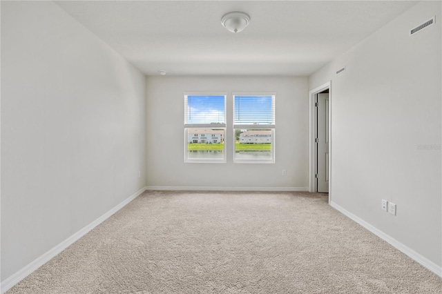 empty room with light colored carpet