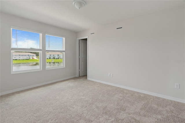 empty room featuring carpet and a water view