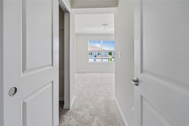 hallway with light colored carpet