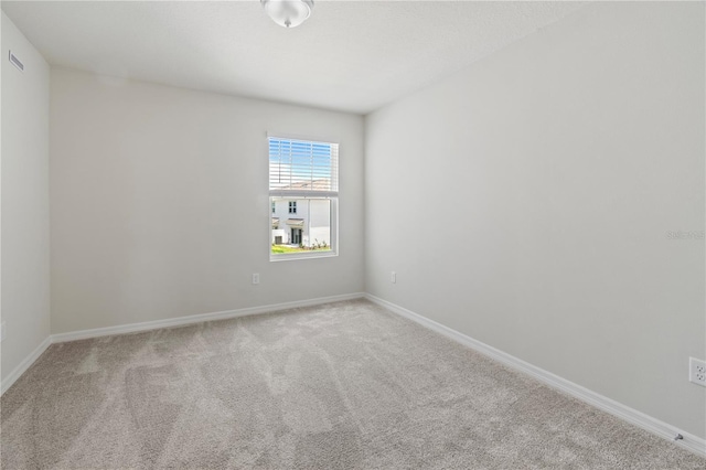 empty room with light colored carpet