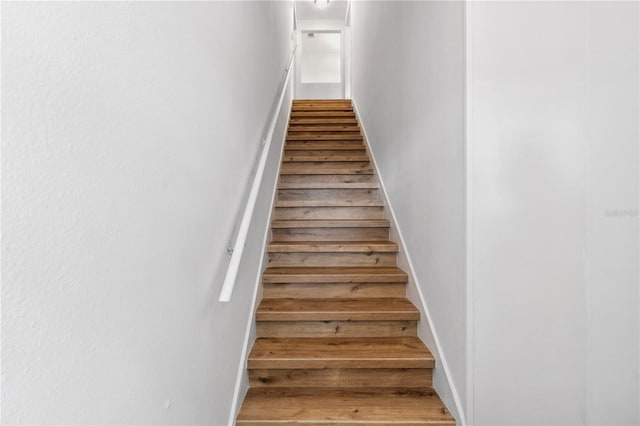 stairs featuring wood-type flooring