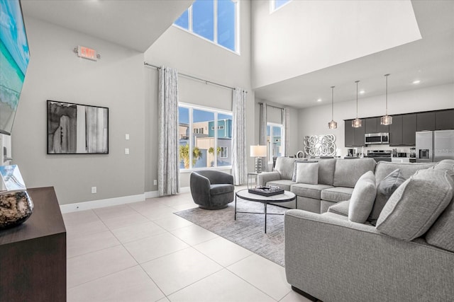 tiled living room featuring a towering ceiling