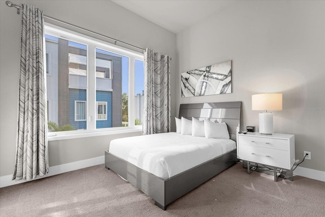 bedroom featuring light colored carpet