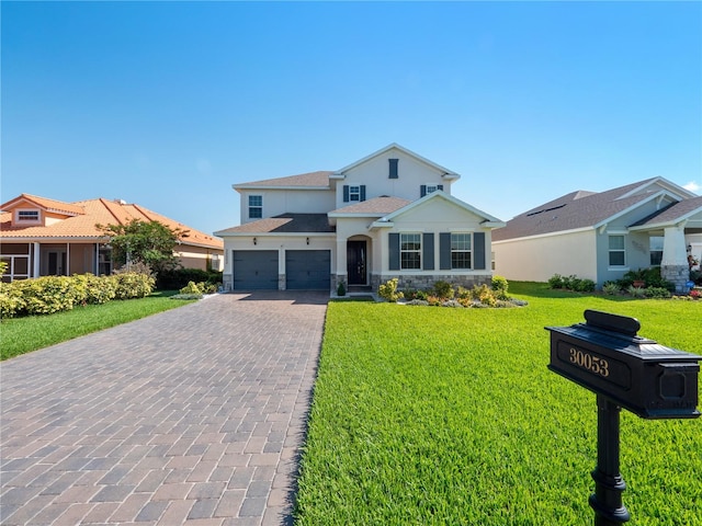 view of front facade featuring a front yard and a garage