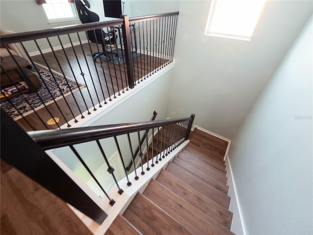 stairs featuring hardwood / wood-style floors