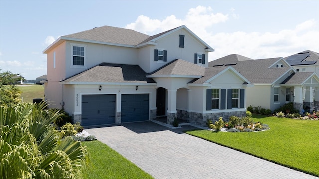 view of front of property with a front lawn and a garage