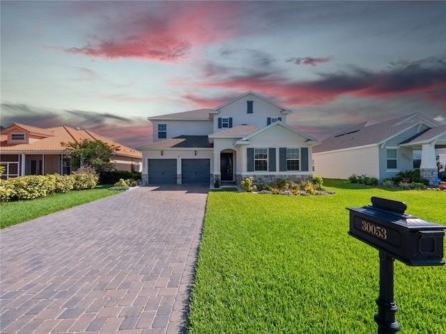 view of front facade featuring a lawn and a garage