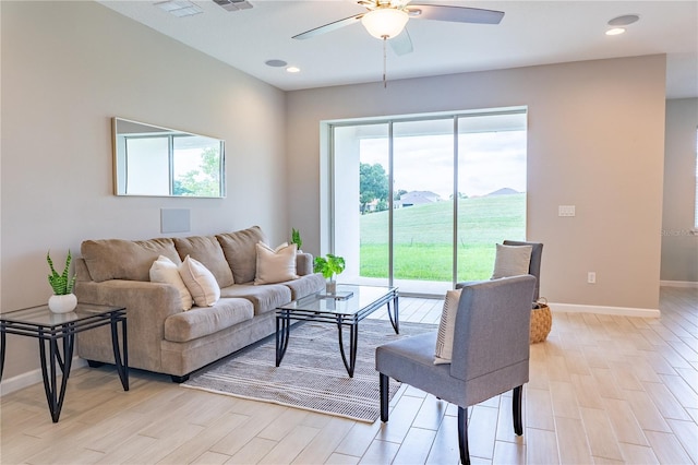 living room with light hardwood / wood-style floors and ceiling fan