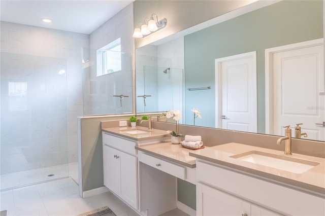 bathroom featuring a tile shower and vanity