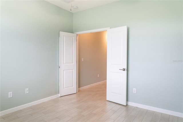 spare room featuring light wood-type flooring