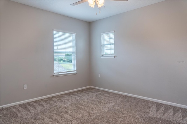 empty room with carpet floors, ceiling fan, and plenty of natural light