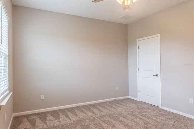 empty room with carpet floors, ceiling fan, and plenty of natural light