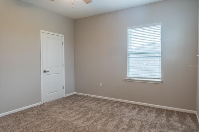 spare room with carpet floors and ceiling fan