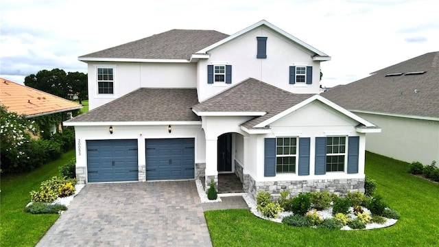 view of front of house with a front lawn and a garage