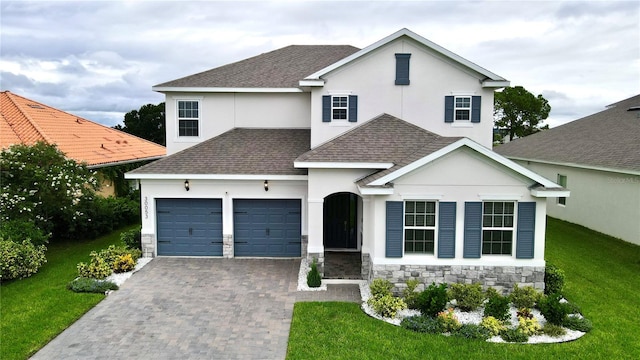 view of front of house with a garage and a front lawn