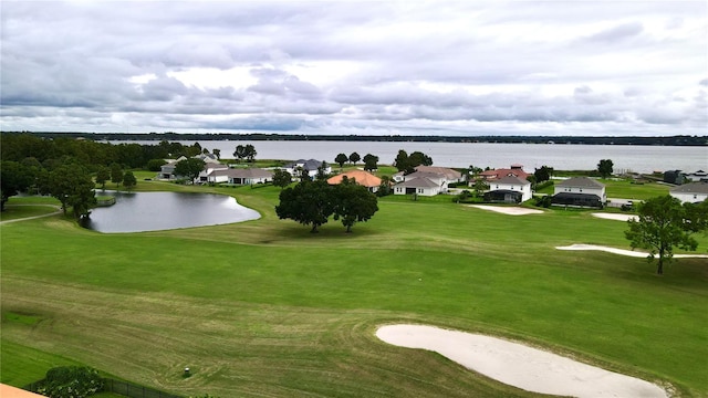 view of home's community with a lawn and a water view