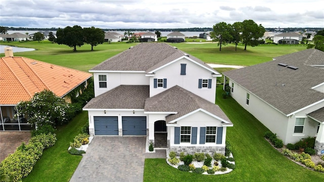 view of front of house with a garage and a front lawn