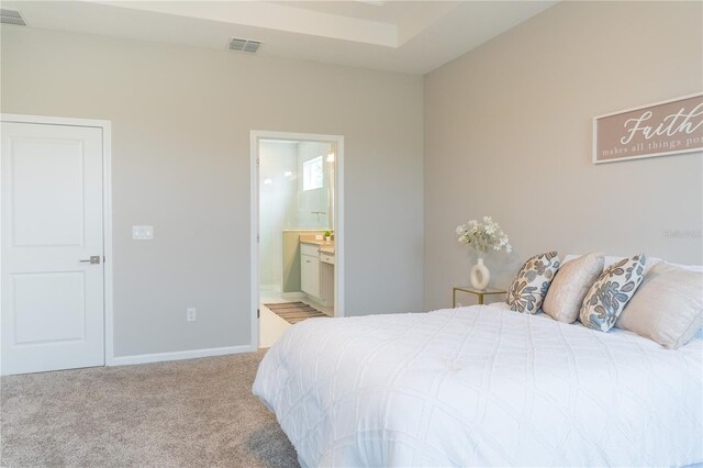 carpeted bedroom featuring connected bathroom