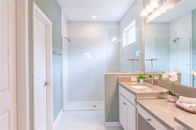 bathroom with vanity and tiled shower