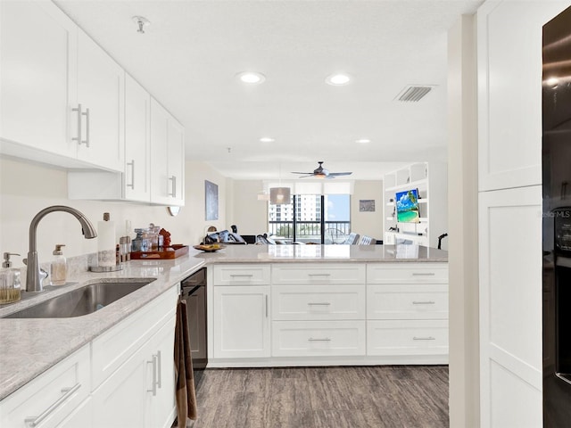 kitchen featuring sink, white cabinets, kitchen peninsula, and light wood-type flooring