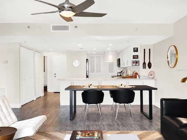 interior space with dark hardwood / wood-style floors and ceiling fan