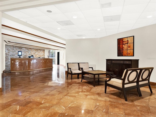 sitting room with a drop ceiling