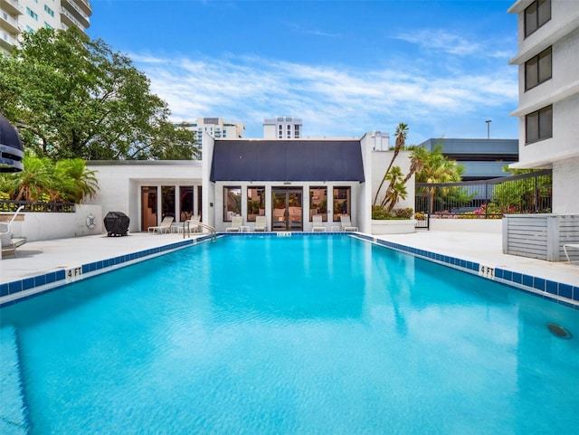 view of pool with a patio area and grilling area