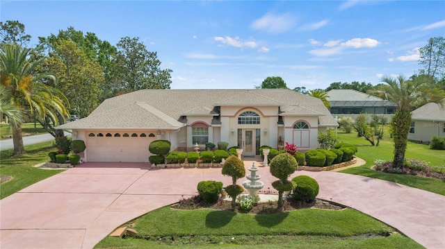 view of front facade with a garage and a front lawn