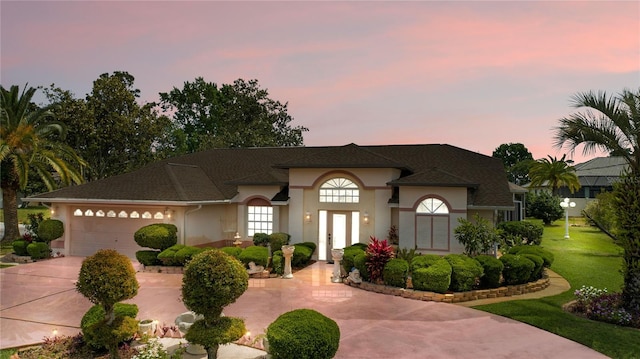 view of front facade with a garage and a yard