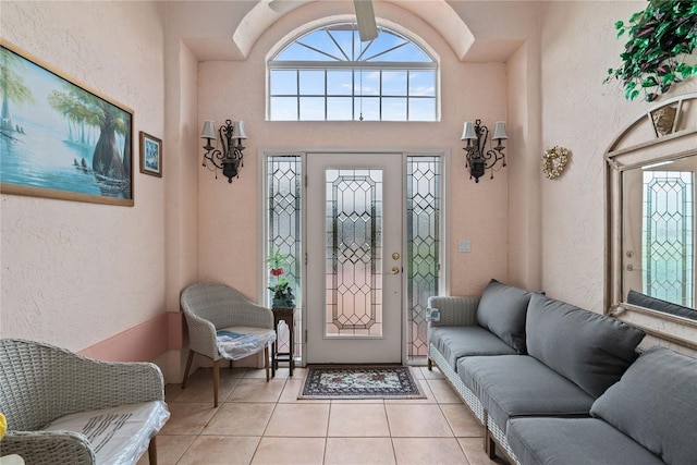 entryway with a high ceiling and light tile patterned floors