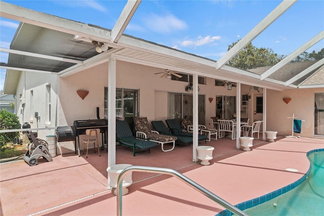 rear view of property featuring a lanai, an outdoor hangout area, ceiling fan, and a patio area