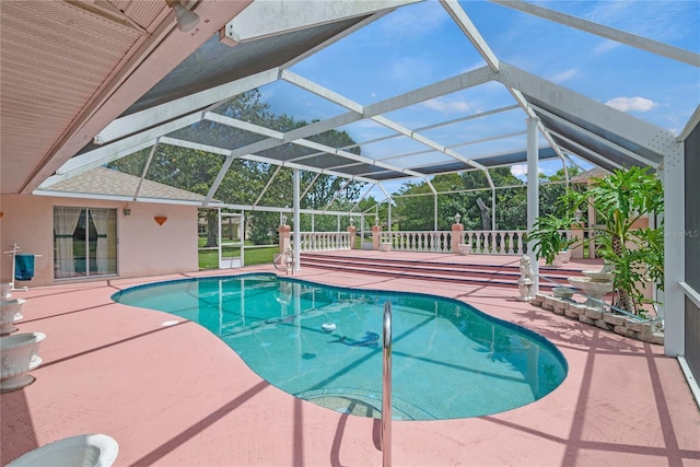 view of swimming pool with a patio area and glass enclosure