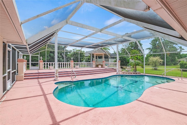 view of swimming pool with a lanai and a patio area